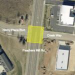 Aerial view of an intersection where Henry Place Blvd meets Creek Way and Peachers Mill Rd; a yellow square marks a lot.