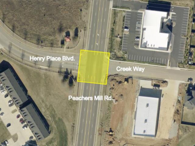 Aerial view of an intersection where Henry Place Blvd meets Creek Way and Peachers Mill Rd; a yellow square marks a lot.