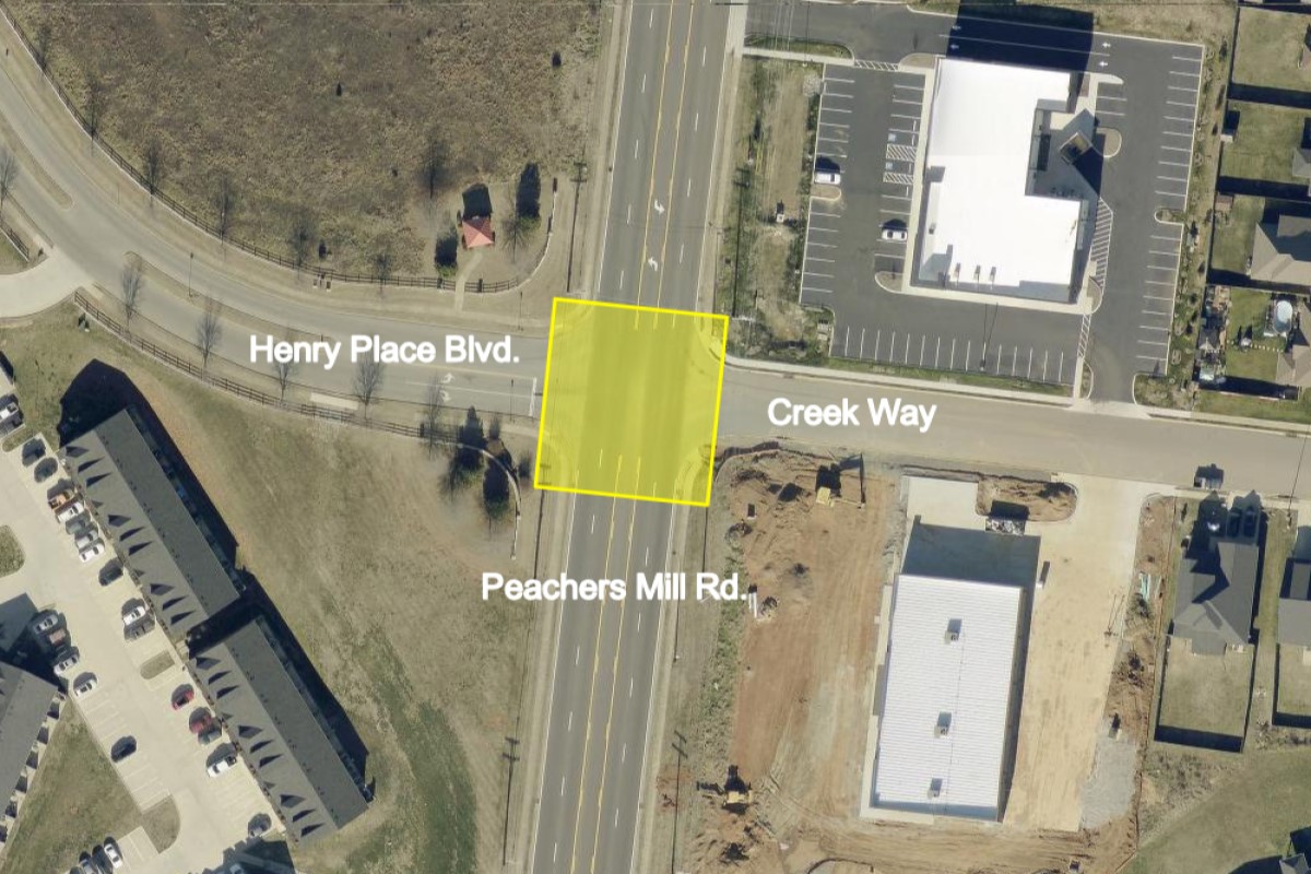 Aerial view of an intersection where Henry Place Blvd meets Creek Way and Peachers Mill Rd; a yellow square marks a lot.