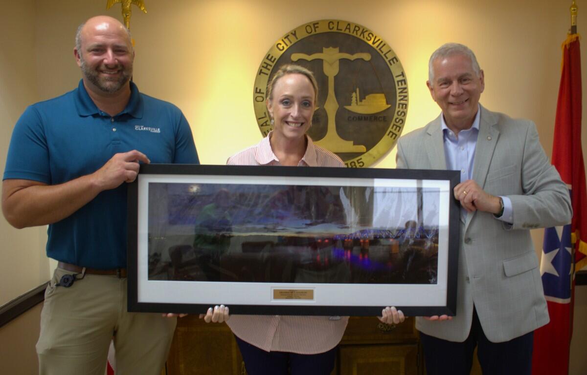 From the left, Justin Crosby, Deanna McLaughlin and Mayor Joe Pitts in recognition of McLaughlin's work on the Restoring Clarksville Initiative. (City of Clarksville, contributed)