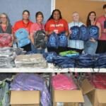 Volunteers with United Way of Greater Nashville and CMCSS Families in Transition pass out free backpacks to students and families at the Back to School Bash at Kenwood High School on Jul 18, 2026. (Lee Erwin)