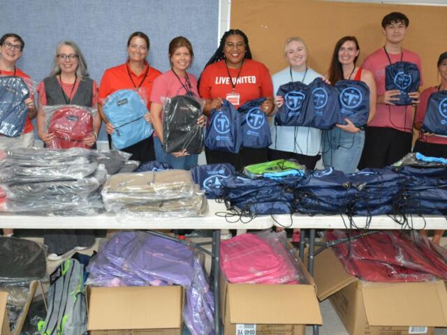 Volunteers with United Way of Greater Nashville and CMCSS Families in Transition pass out free backpacks to students and families at the Back to School Bash at Kenwood High School on Jul 18, 2026. (Lee Erwin)