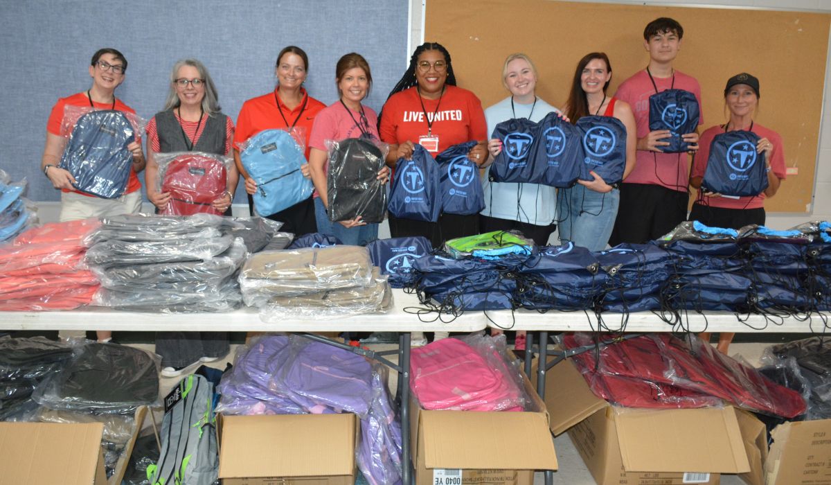 Volunteers with United Way of Greater Nashville and CMCSS Families in Transition pass out free backpacks to students and families at the Back to School Bash at Kenwood High School on Jul 18, 2026. (Lee Erwin)