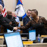 Commissioner Rashidah Leverett, right, congratulates new Commissioner Ted Denny as elected Montgomery County officials are sworn in at the Historic Courthouse on August 31, 2026 (Wesley Irvin)