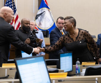 Commissioner Rashidah Leverett, right, congratulates new Commissioner Ted Denny as elected Montgomery County officials are sworn in at the Historic Courthouse on August 31, 2026 (Wesley Irvin)