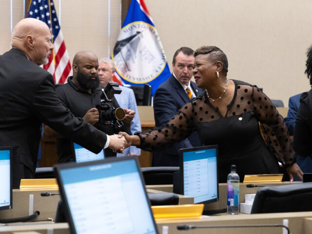 Commissioner Rashidah Leverett, right, congratulates new Commissioner Ted Denny as elected Montgomery County officials are sworn in at the Historic Courthouse on August 31, 2026 (Wesley Irvin)