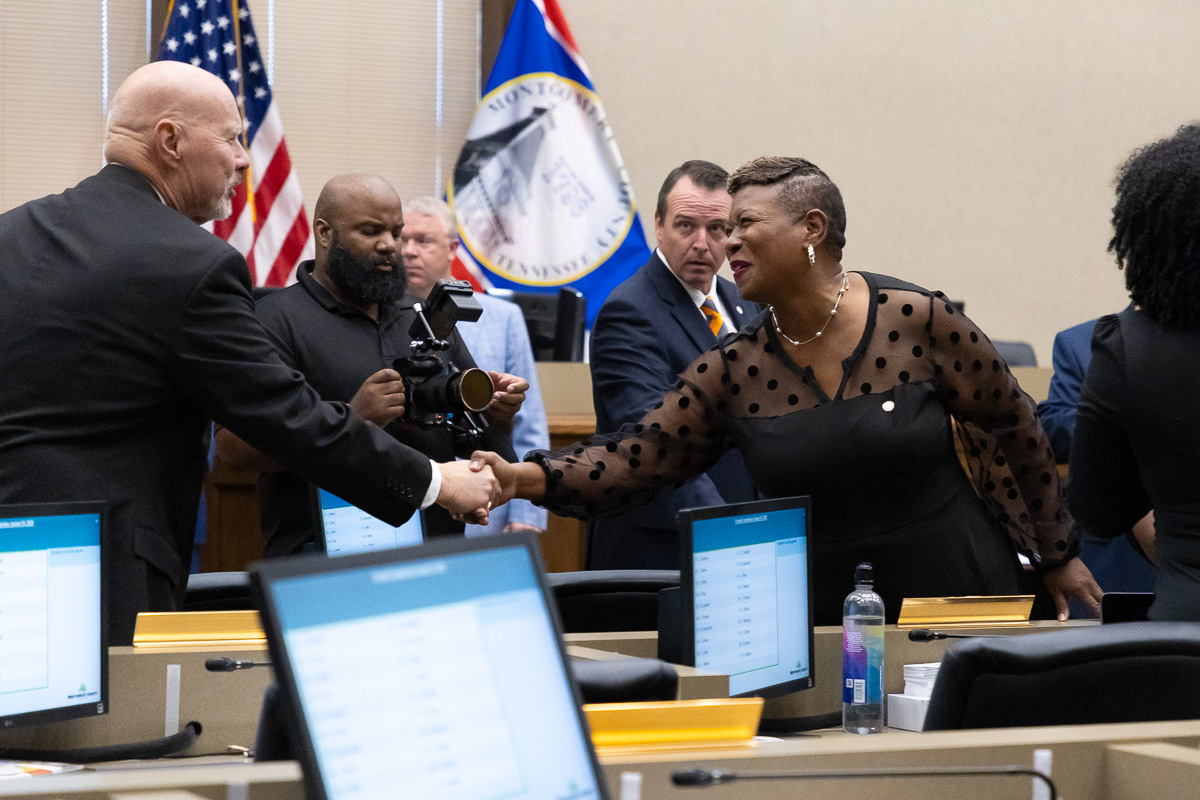 Commissioner Rashidah Leverett, right, congratulates new Commissioner Ted Denny as elected Montgomery County officials are sworn in at the Historic Courthouse on August 31, 2026 (Wesley Irvin)