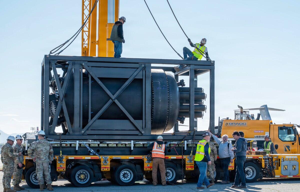 Civilian contractors secure rigging to a containerized nuclear power reactor during staging operations at March Air Reserve Base, Calif., Feb. 13, 2026. (Air Force Staff Sgt. Monique Bright, contributed)