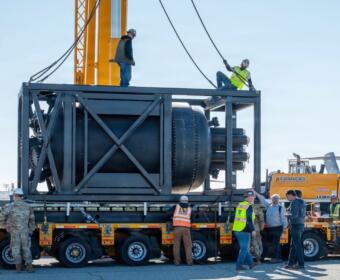 Civilian contractors secure rigging to a containerized nuclear power reactor during staging operations at March Air Reserve Base, Calif., Feb. 13, 2026. (Air Force Staff Sgt. Monique Bright, contributed)
