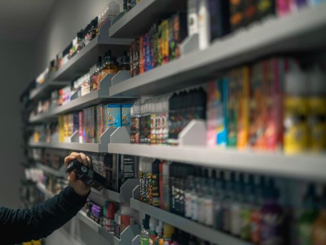 Vape liquids in a smoke shop. (Unsplash)