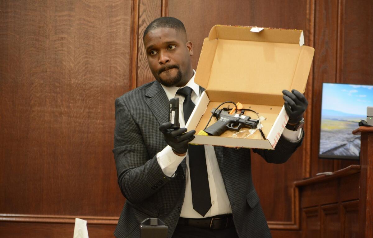 Agent Xavier Greaves holding up the murder weapon for jurors at the Montgomery County Courts Center on Sept. 28, 2026. (Jazmin Logan)