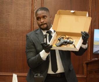 Agent Xavier Greaves holding up the murder weapon for jurors at the Montgomery County Courts Center on Sept. 28, 2026. (Jazmin Logan)