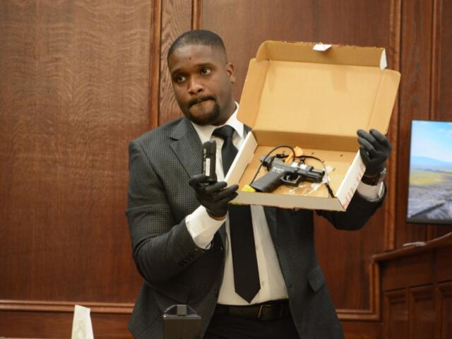 Agent Xavier Greaves holding up the murder weapon for jurors at the Montgomery County Courts Center on Sept. 28, 2026. (Jazmin Logan)