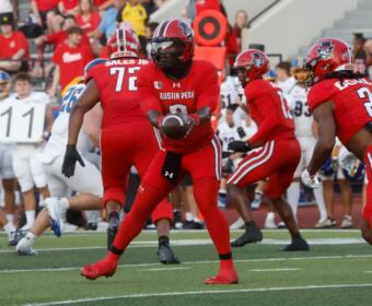 Chris Parson hands the ball off against Morehead State on September 13, 2025. (Robert Smith, APSU Athletics).