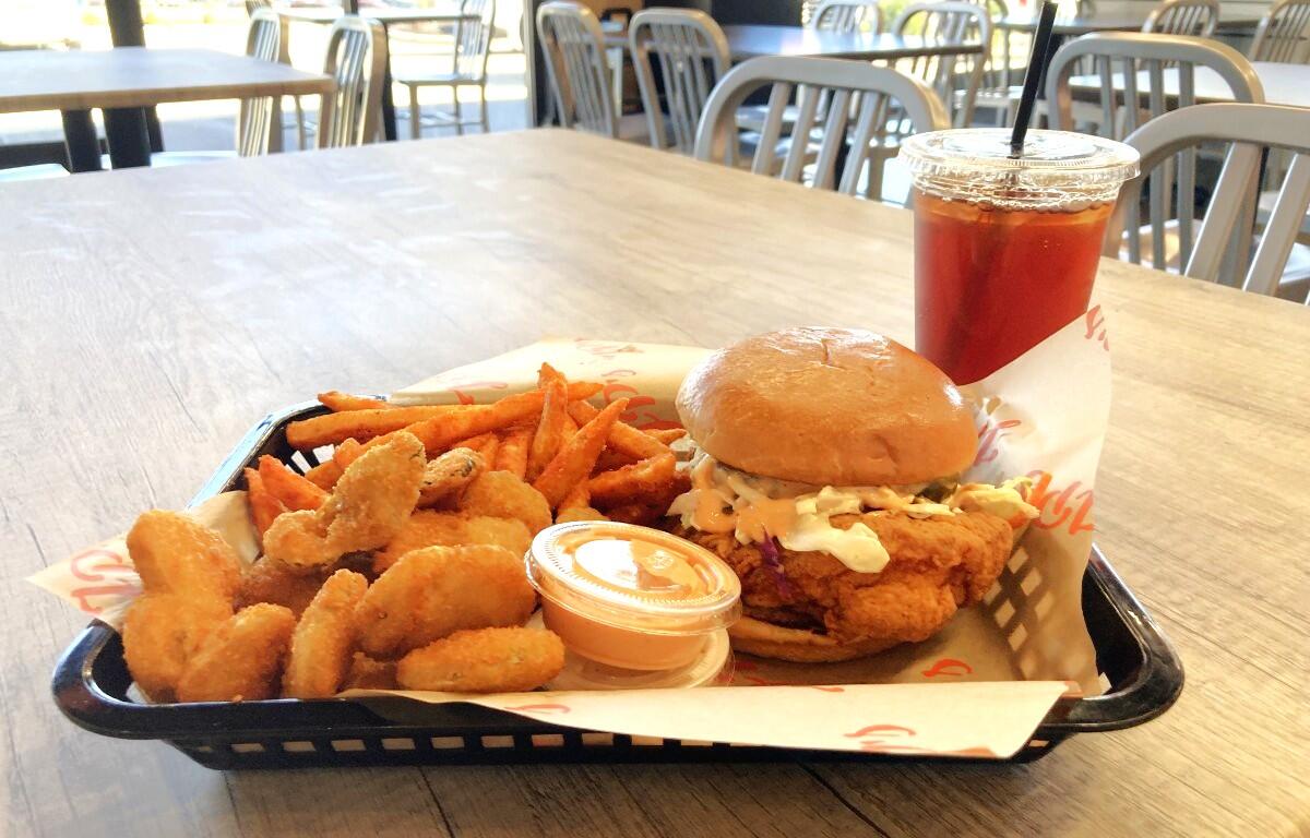 Combo meal at JP's Hot Chicken Clarksville location featuring their signature sandwich, and a side of fried pickles, Cajun fries and a sweet tea. (Christian Brown)