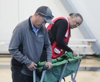 Volunteers set up beds in a Red Cross shelter. (Red Cross, contributed)